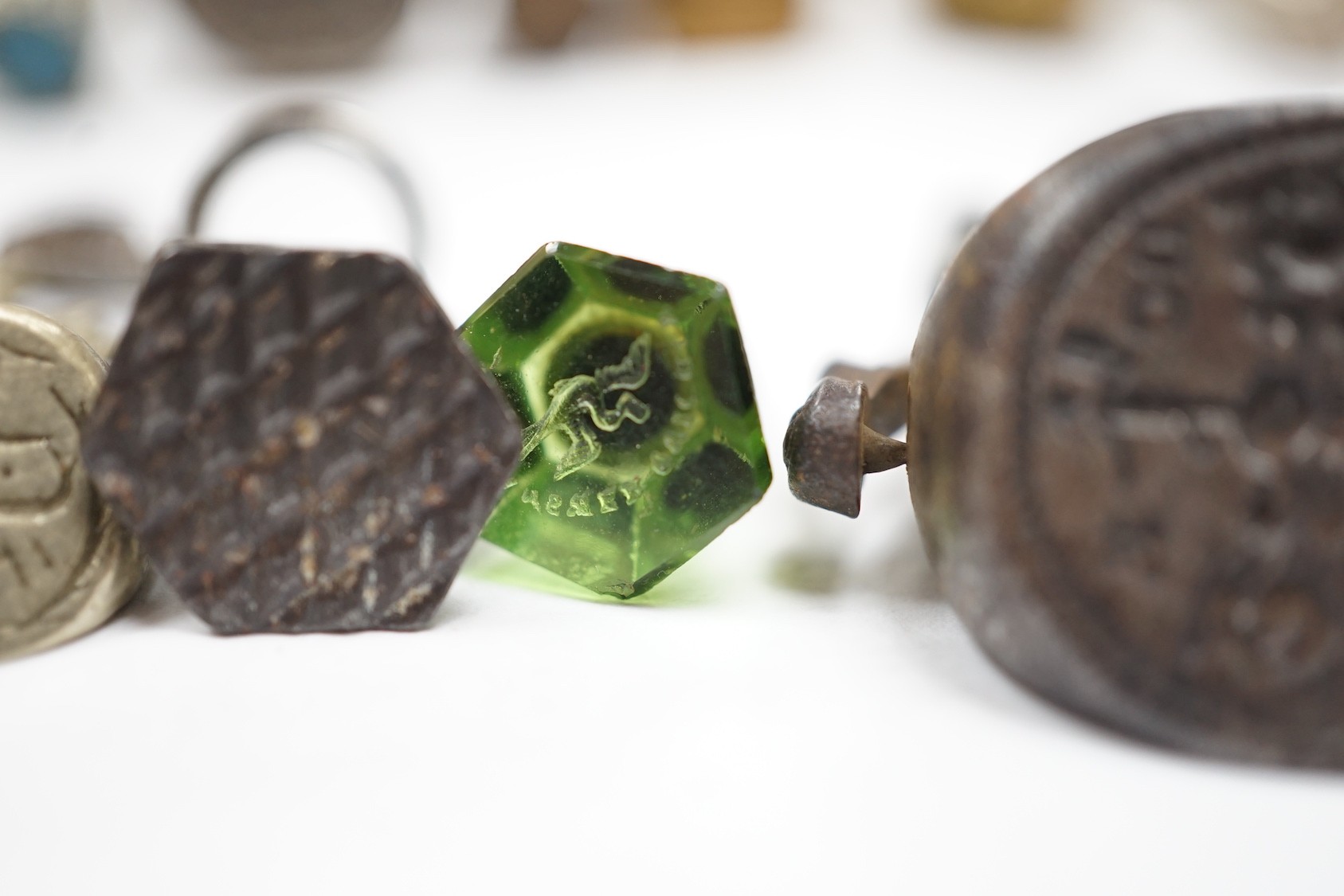 A group of twenty-five steel, gilt metal or nickel fob or desk seals, mostly 19th-century, including a steel swivel seal, a seal with boxwood finial modelled as a hand holding a ball and a nickel multi seal